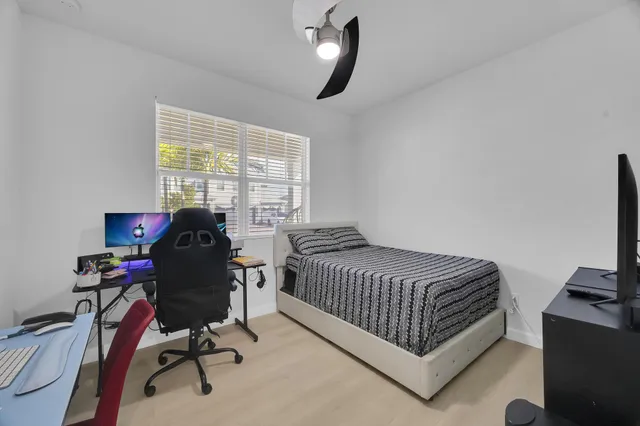 a bedroom with bed and a window