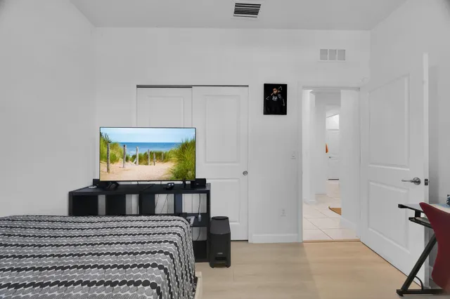 a bedroom with a bed and a flat screen tv
