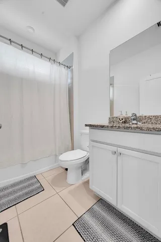 a spacious bathroom with a double vanity sink and a mirror