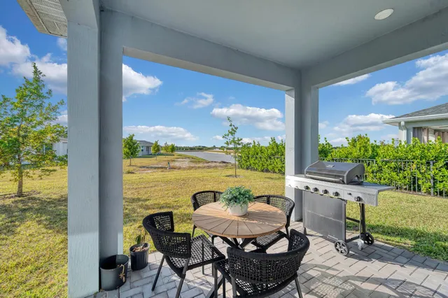 a dining room with furniture a floor to ceiling window and a flat screen tv