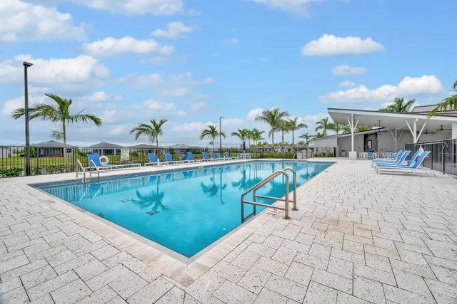 a view of a patio with a table and chairs under an umbrella