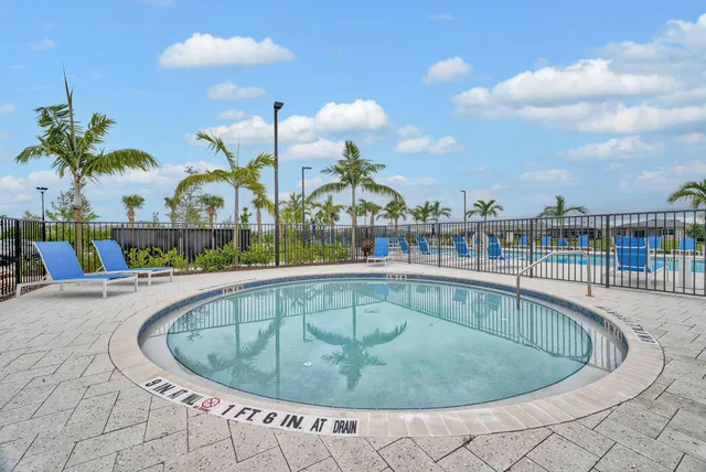 a view of a brick house with a yard and plants