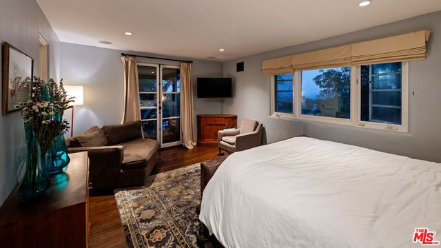 a bedroom with a large bed and a window