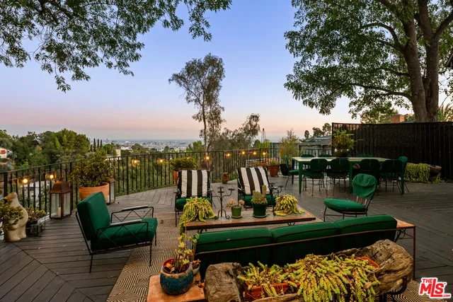 a view of a lake with couches chairs