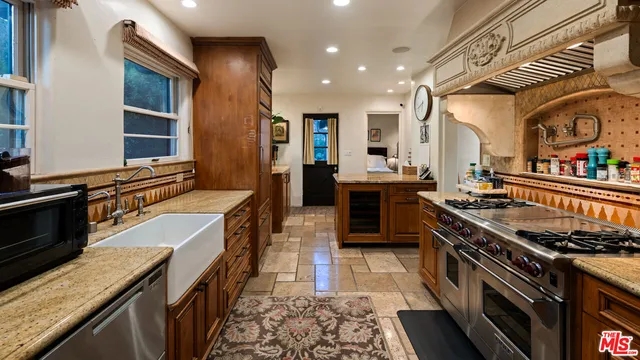 a kitchen with stainless steel appliances granite countertop a stove and a sink