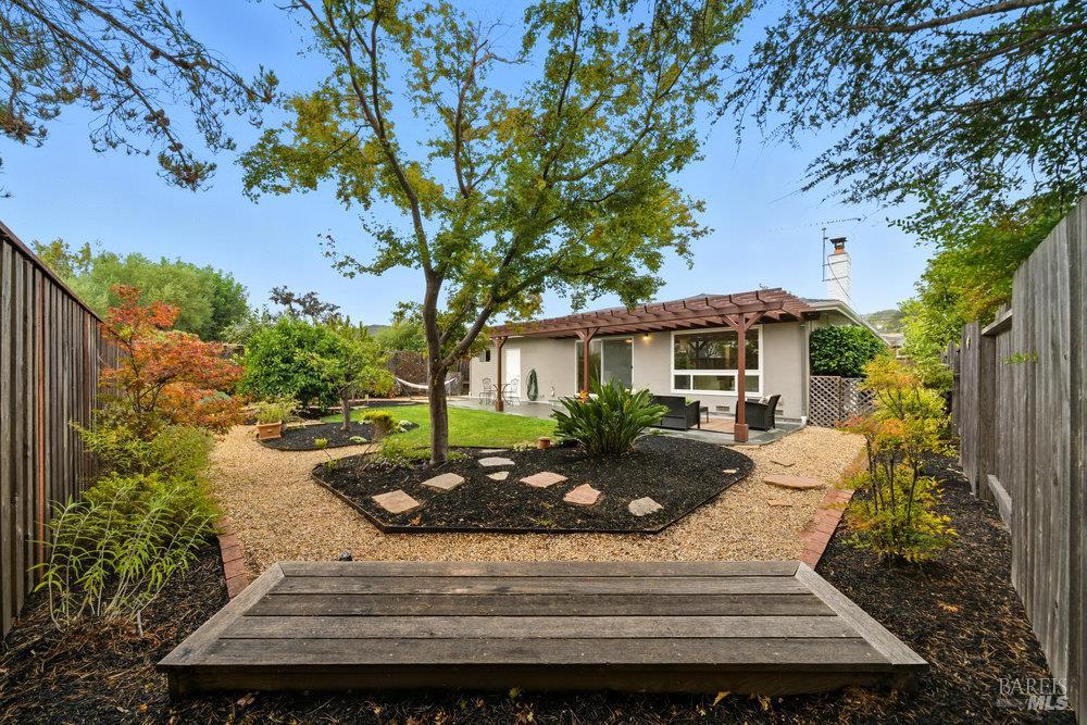 a view of a house with backyard and sitting area
