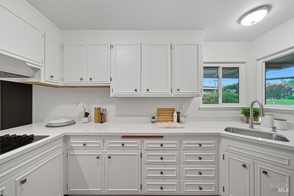 934 Las Pavadas Avenue San Rafael, CA 94903 - Photo 12 of 36 a kitchen with cabinets appliances a sink a faucet and a window