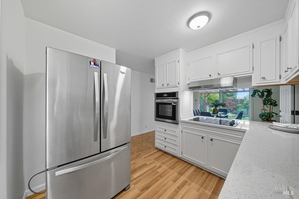 934 Las Pavadas Avenue San Rafael, CA 94903 - Photo 14 of 36 a kitchen with stainless steel appliances a refrigerator sink and cabinets
