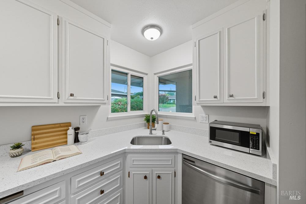 934 Las Pavadas Avenue San Rafael, CA 94903 - Photo 16 of 36 a kitchen with white cabinets and a sink