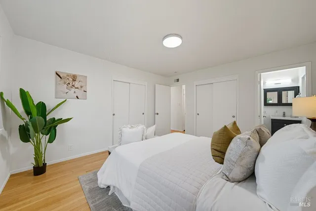 a bedroom with a bed and a potted plant