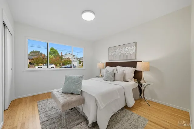 a bedroom with a bed and a painting on the wall