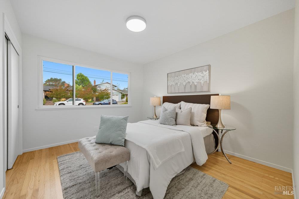 934 Las Pavadas Avenue San Rafael, CA 94903 - Photo 23 of 36 a bedroom with a bed and a painting on the wall
