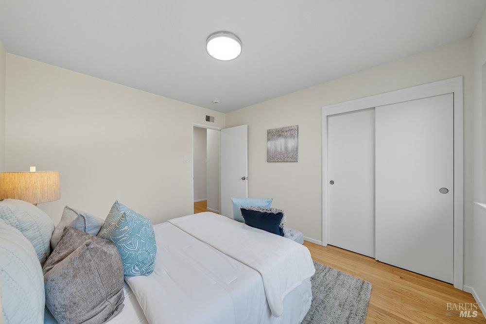 934 Las Pavadas Avenue San Rafael, CA 94903 - Photo 24 of 36 a bedroom with a bed and a night stand