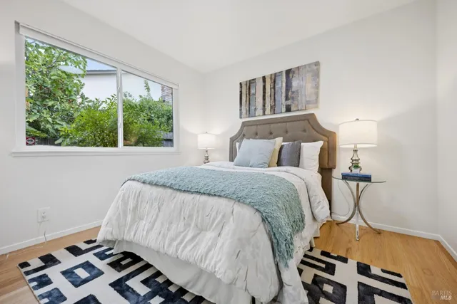 a bedroom with a bed and a window