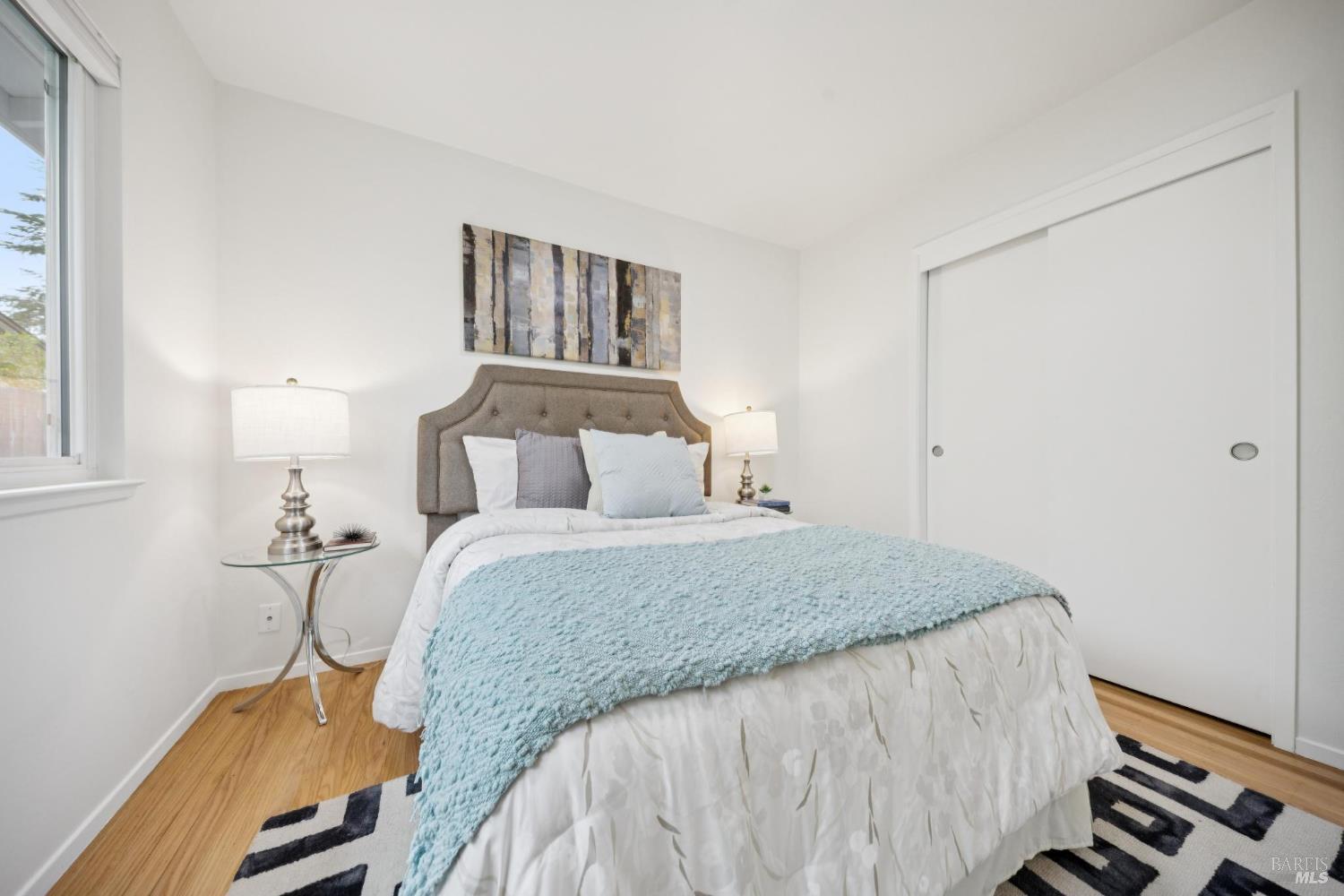 934 Las Pavadas Avenue San Rafael, CA 94903 - Photo 27 of 36 a bedroom with a bed and wooden floor