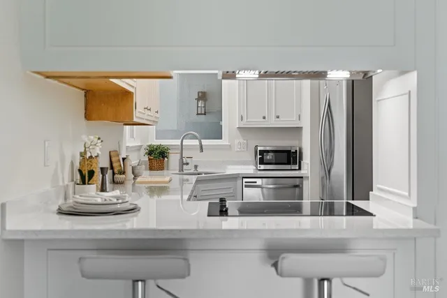 a kitchen with stainless steel appliances granite countertop a refrigerator and cabinets