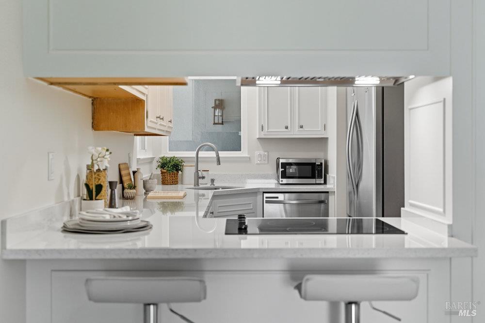 934 Las Pavadas Avenue San Rafael, CA 94903 - Photo 3 of 36 a kitchen with stainless steel appliances granite countertop a refrigerator and cabinets