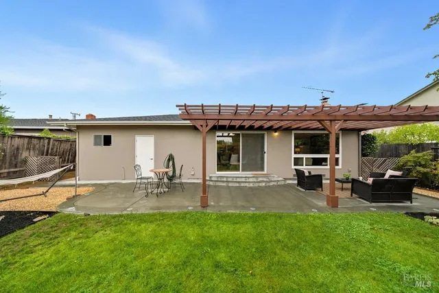 a view of a house with backyard porch and sitting area