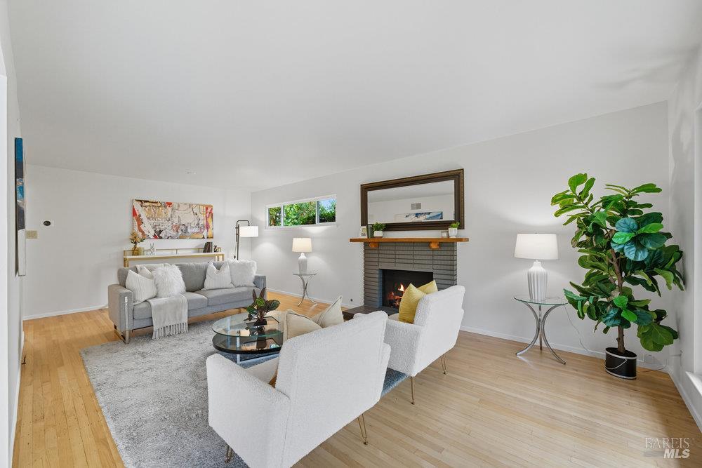 934 Las Pavadas Avenue San Rafael, CA 94903 - Photo 8 of 36 a living room with furniture a fireplace and potted plants