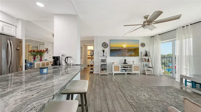a living room with furniture wooden floor and a flat screen tv