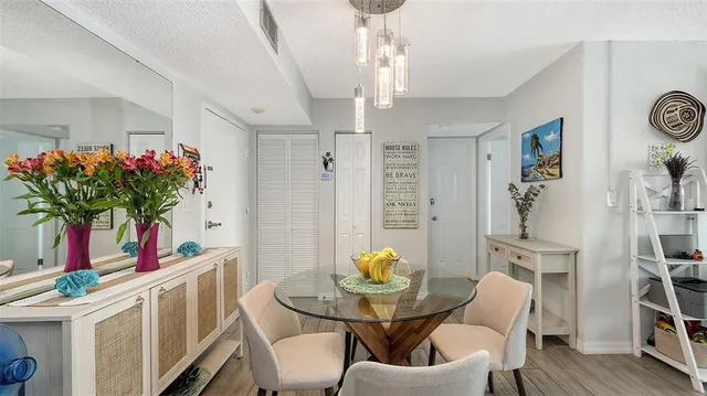 a view of a dining room with furniture and a chandelier