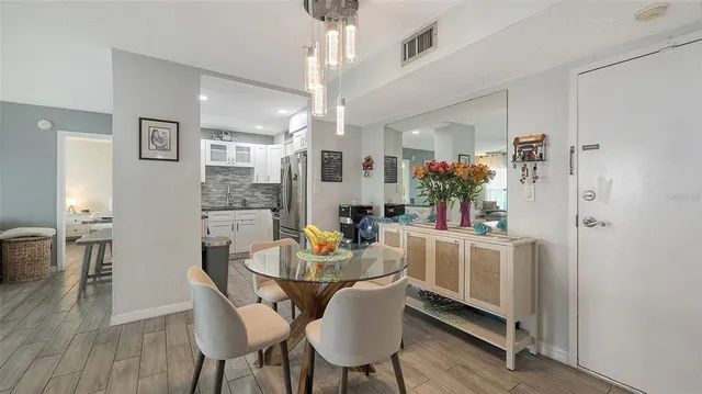 a dining room with furniture and wooden floor