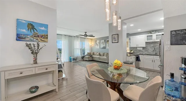 a living room with furniture and kitchen view