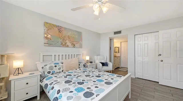 a bedroom with a large bed and a chandelier