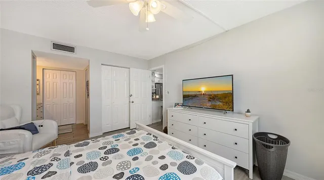 a bedroom with a bed and flat screen tv