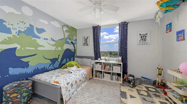 a bedroom with a bed and a wooden floor