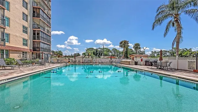 a house with swimming pool and outdoor seating
