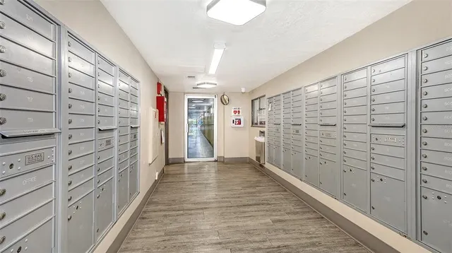 a view of a workspace with furniture and book shelf