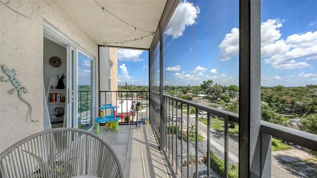 a view of a balcony with potted plants