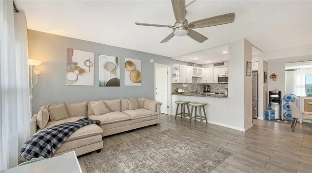a living room with furniture and kitchen view