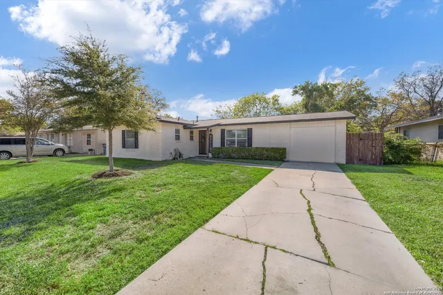 a view of house with backyard
