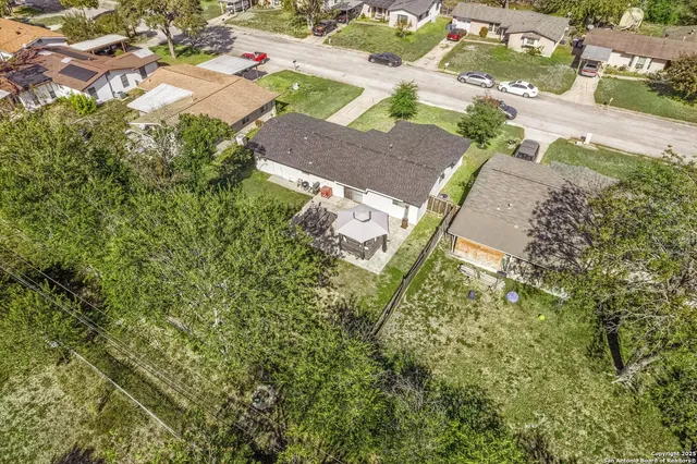 an aerial view of house with yard