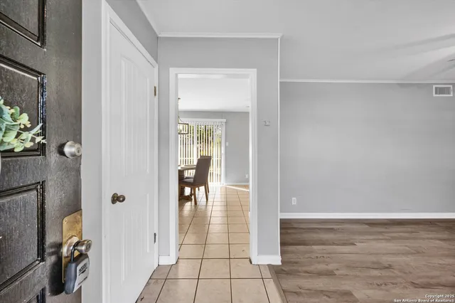 a view of livingroom with hardwood floor and a hallway
