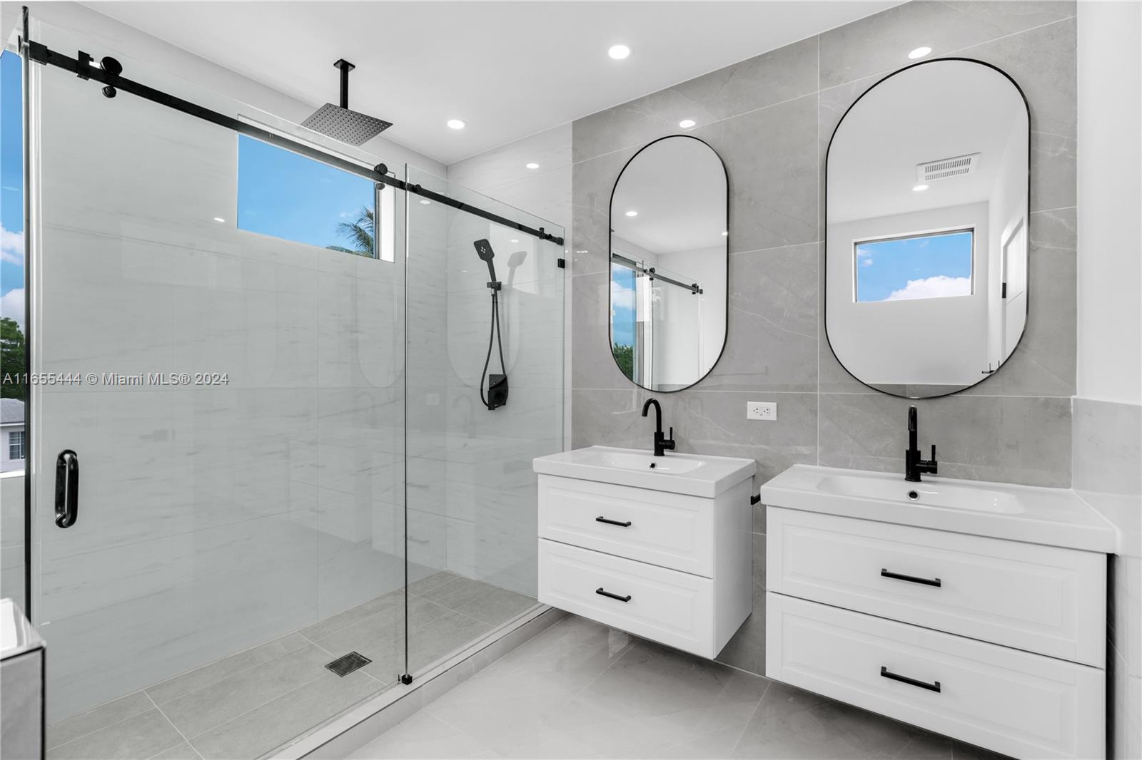 2340 Southwest 13th Street, Unit 2340 Miami, FL 33145 - Photo 14 of 26 a en suite bathroom with a double vanity sink and a mirror