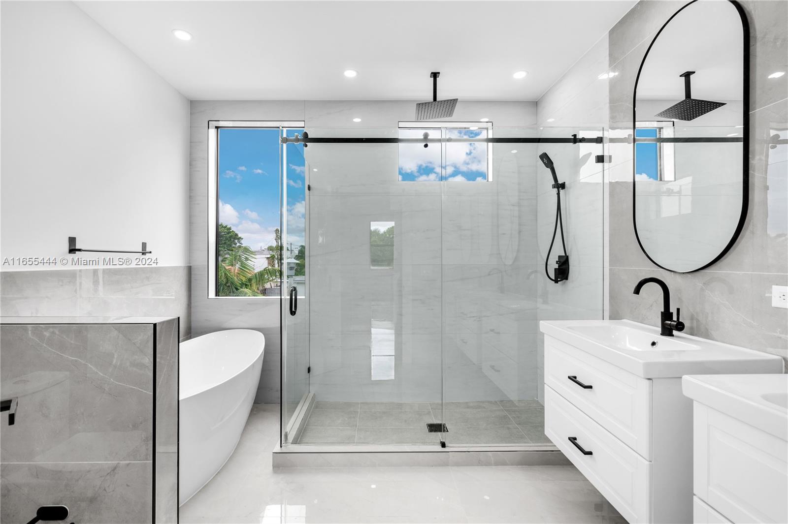 2340 Southwest 13th Street, Unit 2340 Miami, FL 33145 - Photo 15 of 26 a bathroom with a sink mirror and shower