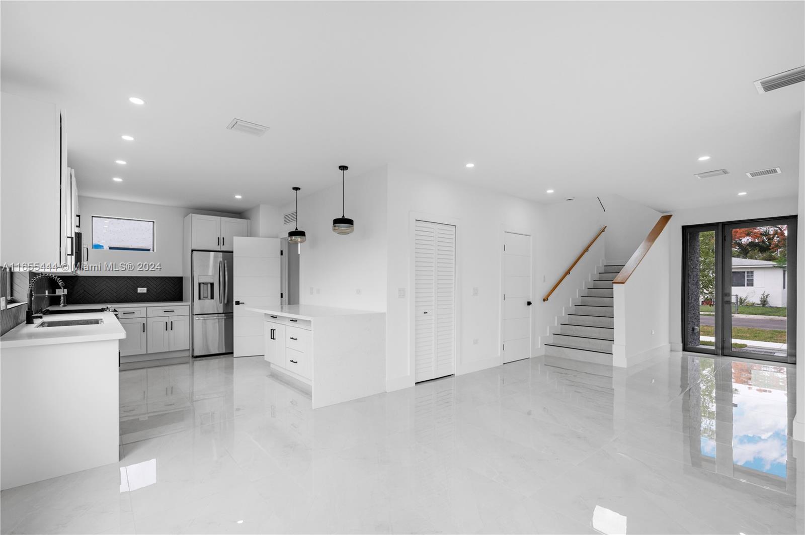 2340 Southwest 13th Street, Unit 2340 Miami, FL 33145 - Photo 2 of 26 a large white kitchen with white stainless steel appliances