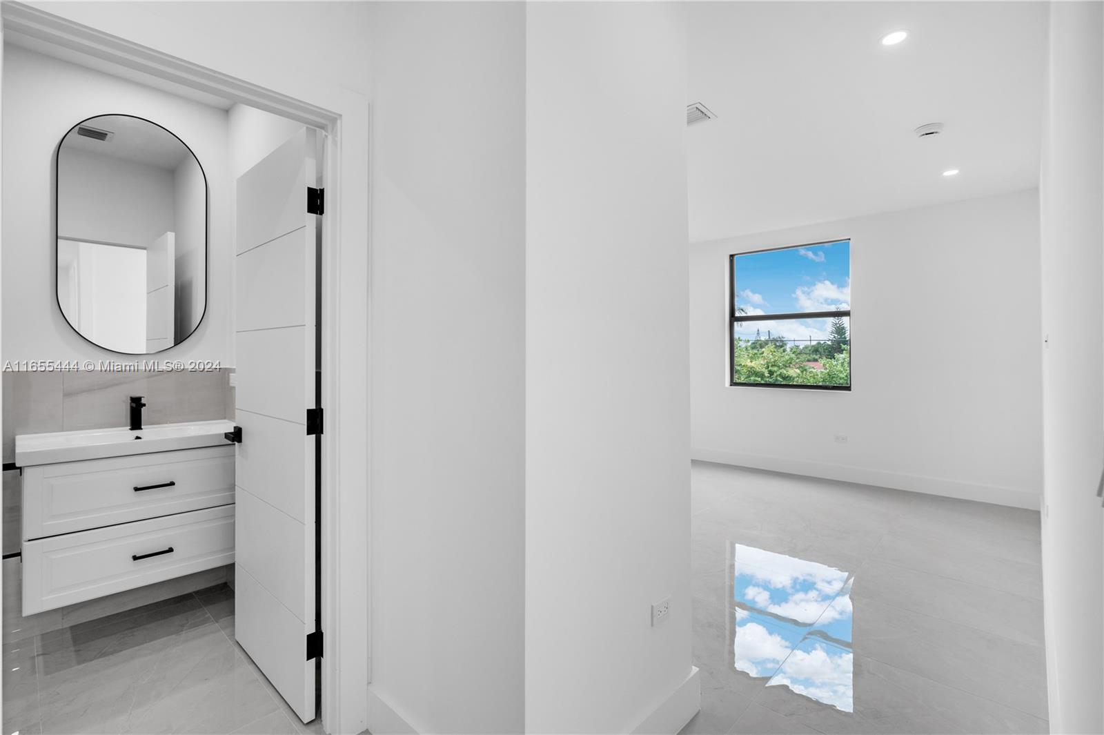 2340 Southwest 13th Street, Unit 2340 Miami, FL 33145 - Photo 21 of 26 a bathroom with a sink mirror and vanity