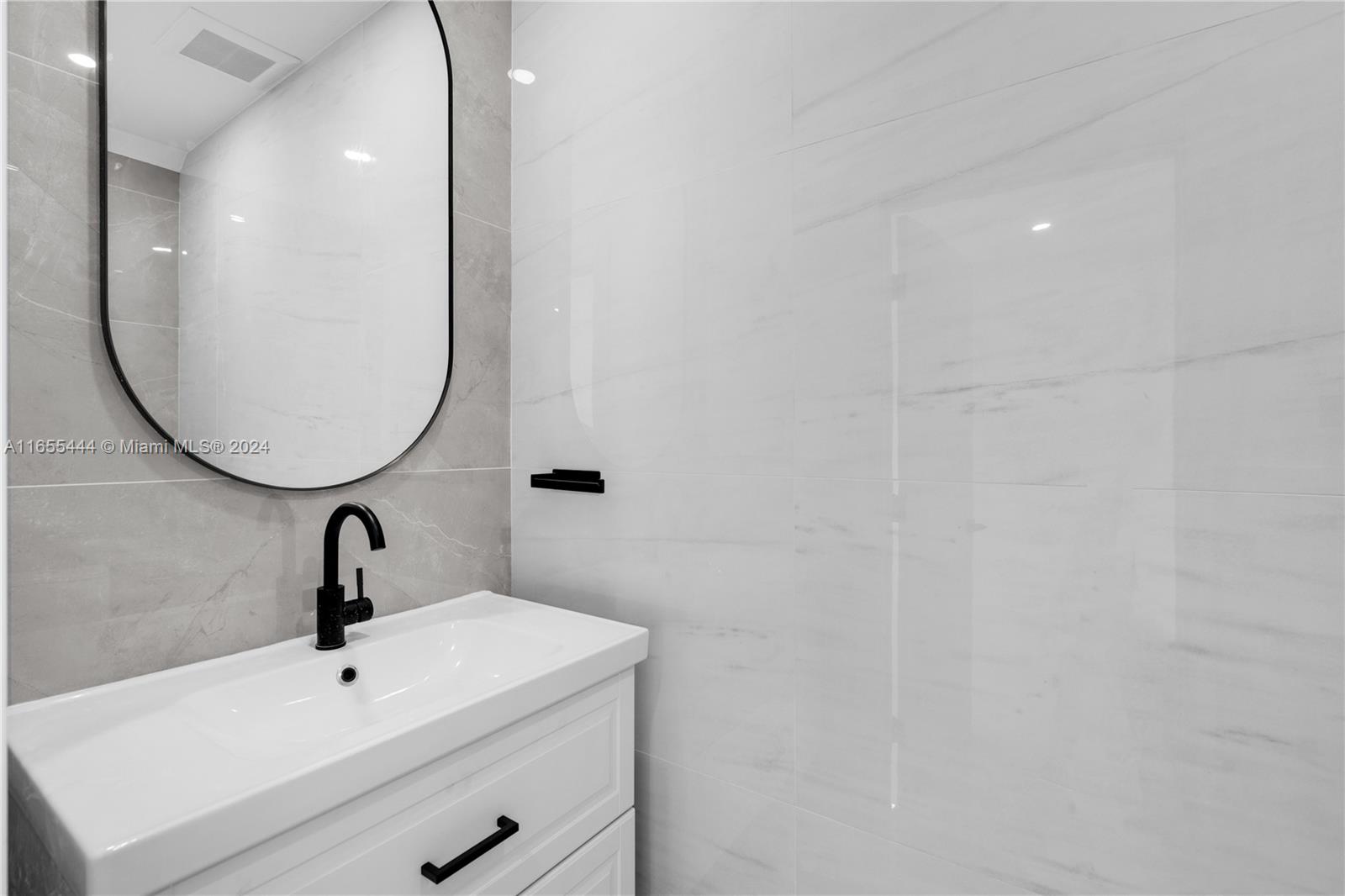2340 Southwest 13th Street, Unit 2340 Miami, FL 33145 - Photo 10 of 26 a bathroom with a sink and mirror