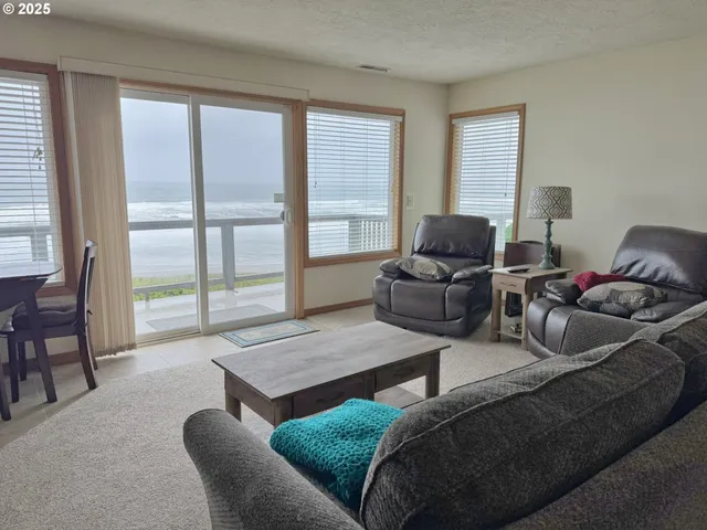 a living room with furniture and a floor to ceiling window