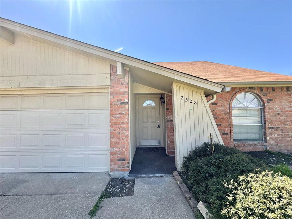 2508 South Center Street Arlington, TX 76014 - Photo 2 of 17 a front view of a house with garden