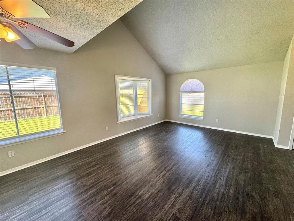 2508 South Center Street Arlington, TX 76014 - Photo 4 of 17 an empty room with wooden floor and windows