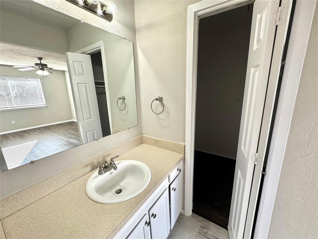 2508 South Center Street Arlington, TX 76014 - Photo 8 of 17 a bathroom with a sink and a mirror