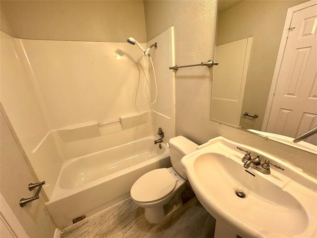 2508 South Center Street Arlington, TX 76014 - Photo 9 of 17 a bathroom with a sink toilet and shower