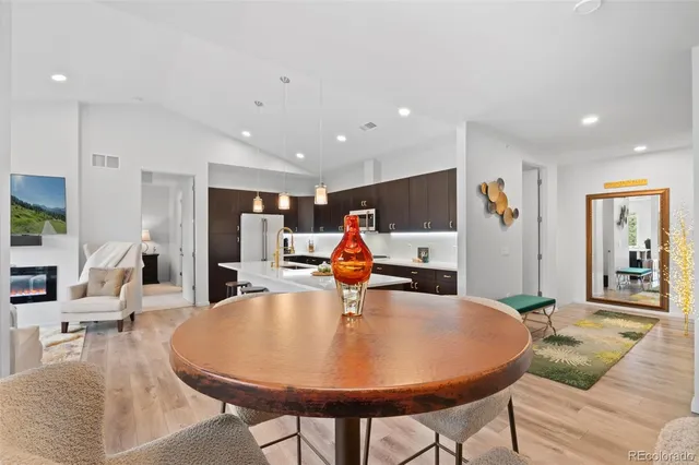 a living room with furniture and kitchen view