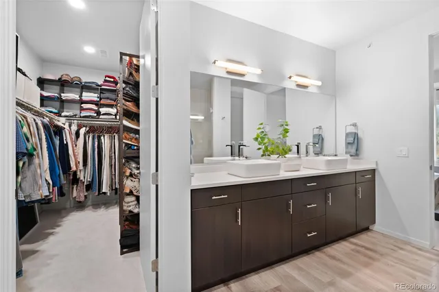 a bathroom with a double vanity sink mirror and shower