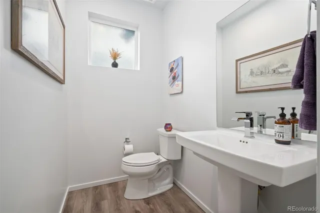 a bathroom with a sink mirror and toilet